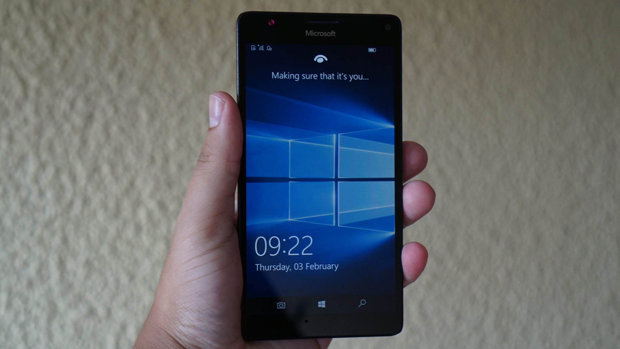 Windows 10 Mobile lockscreen Windows 10 Mobile lockscreen on phone in hand
